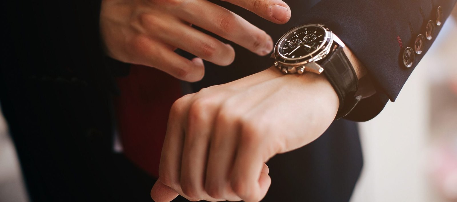 Closeup businessman looks at his watch